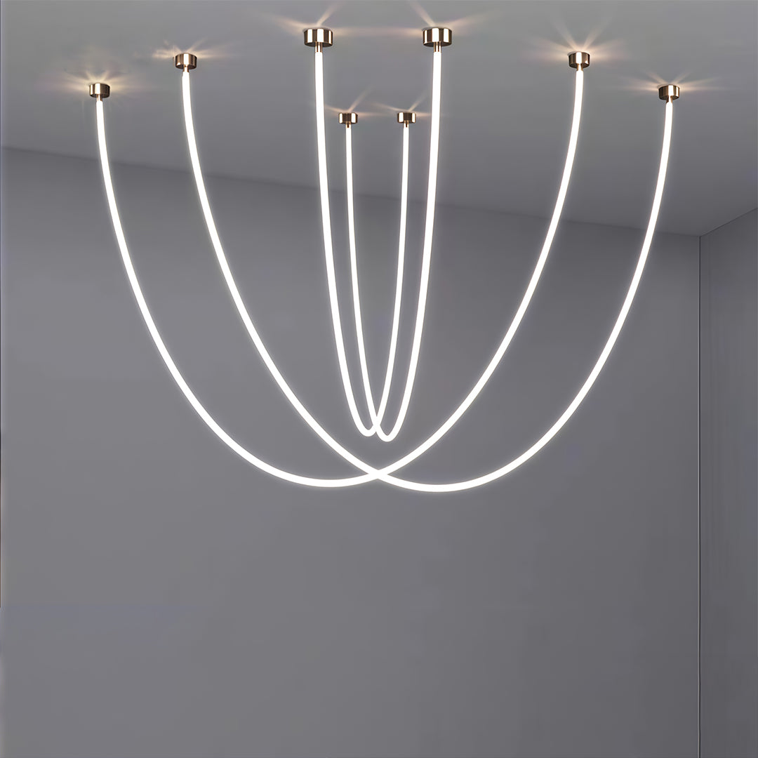 Collection of neon pendant lights with varying heights and curves displayed on neutral grey background.