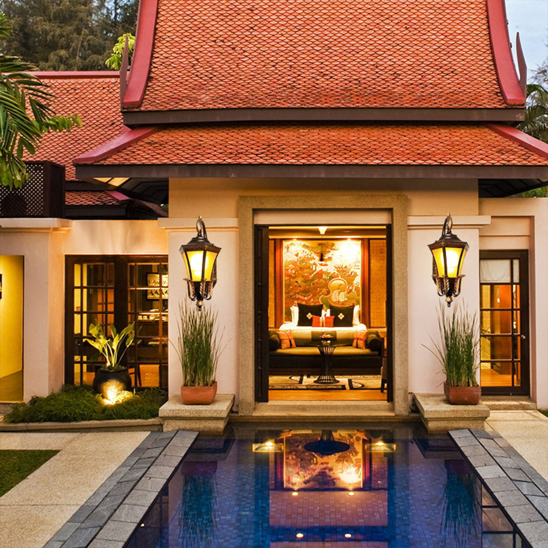Elegant colonial-style outdoor lanterns illuminating luxury poolside terrace with traditional architecture and warm ambient lighting