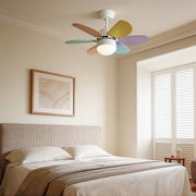 Colored fan with light enhancing a cozy bedroom with vibrant rainbow blades and warm illumination.