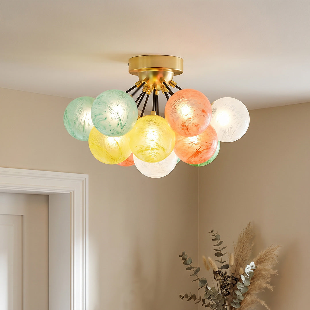 Colored glass flush mount ceiling light fixture with multicolor globes illuminating a cozy modern living room.