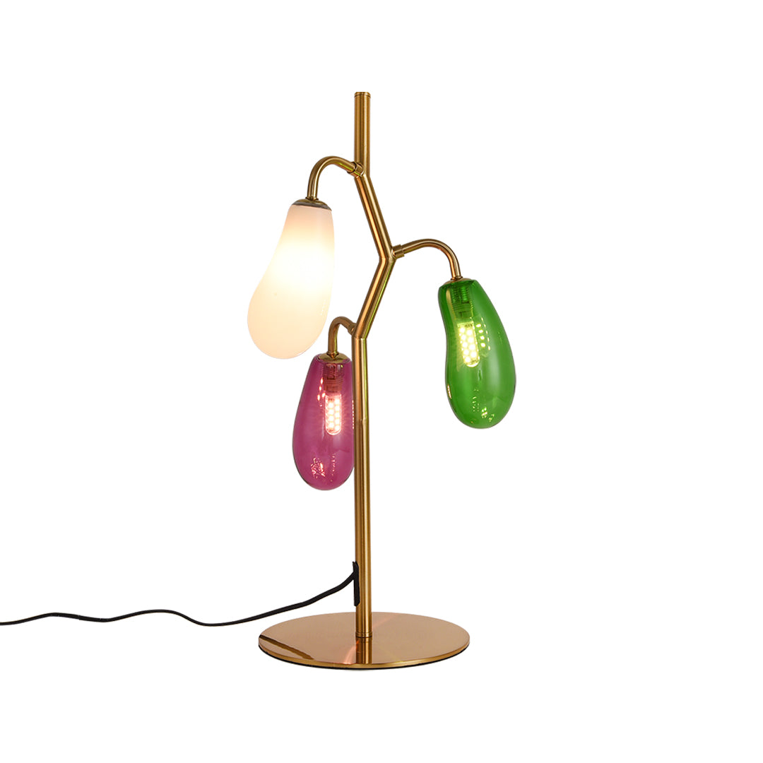 Full view of colored glass table lamp with three-light branch design.