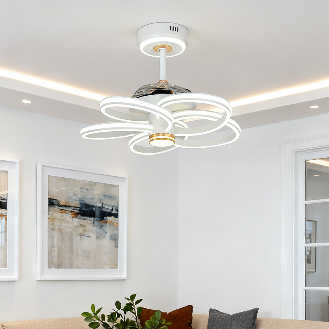 Ceiling fans white with light and colorful border centered above a minimalist bed in a calm, soft-pink children's room. 