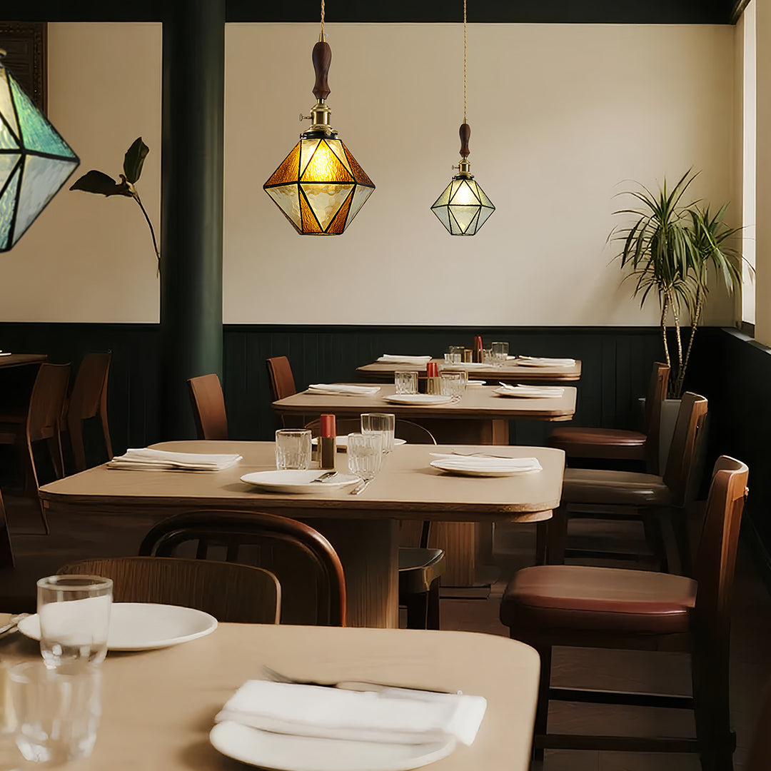 Colorful diamond-shaped pendant lights in stylish dining space with natural wood and contemporary restaurant atmosphere