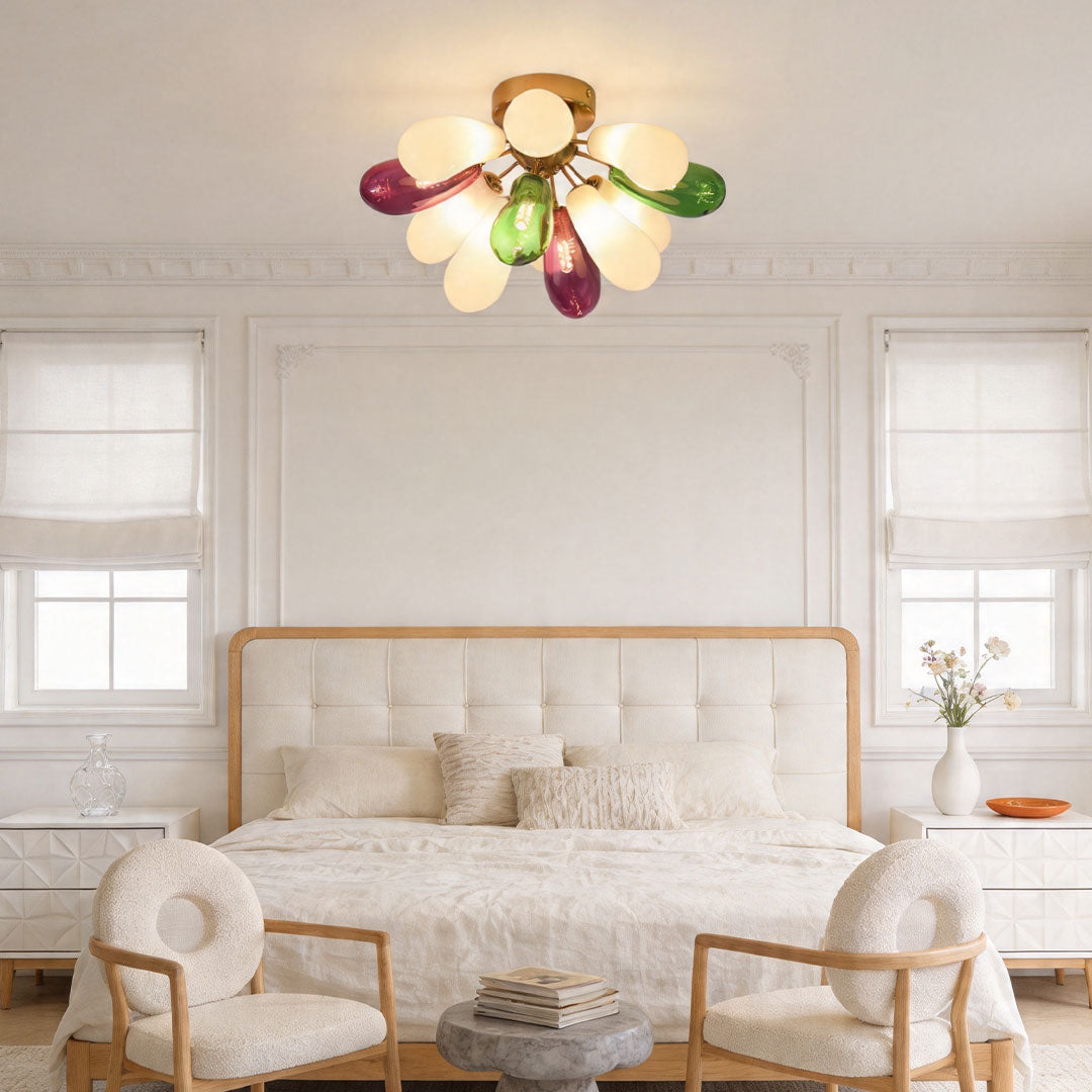 Colorful glass flush mount ceiling fixture in a minimalist bedroom creating a warm and playful atmosphere.