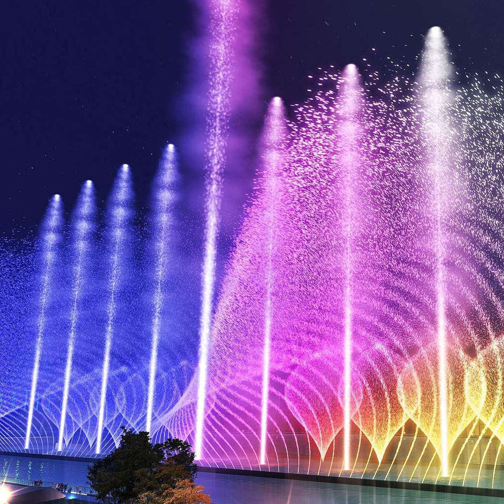Colorful LED fountain lights creating spectacular purple and pink water display at night