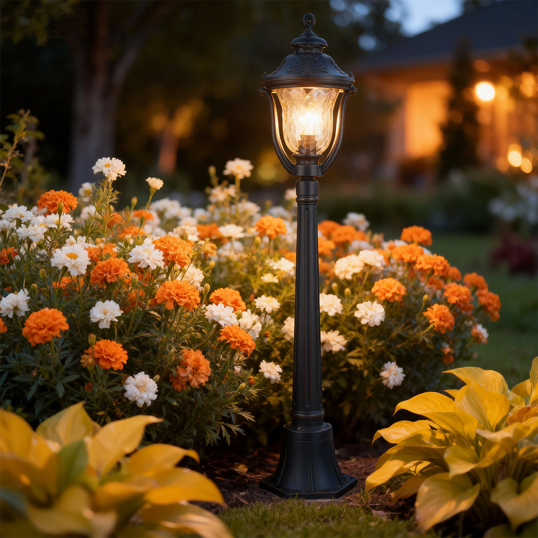 Bollard post light in a colorful garden, elegant and functional outdoor lighting fixture