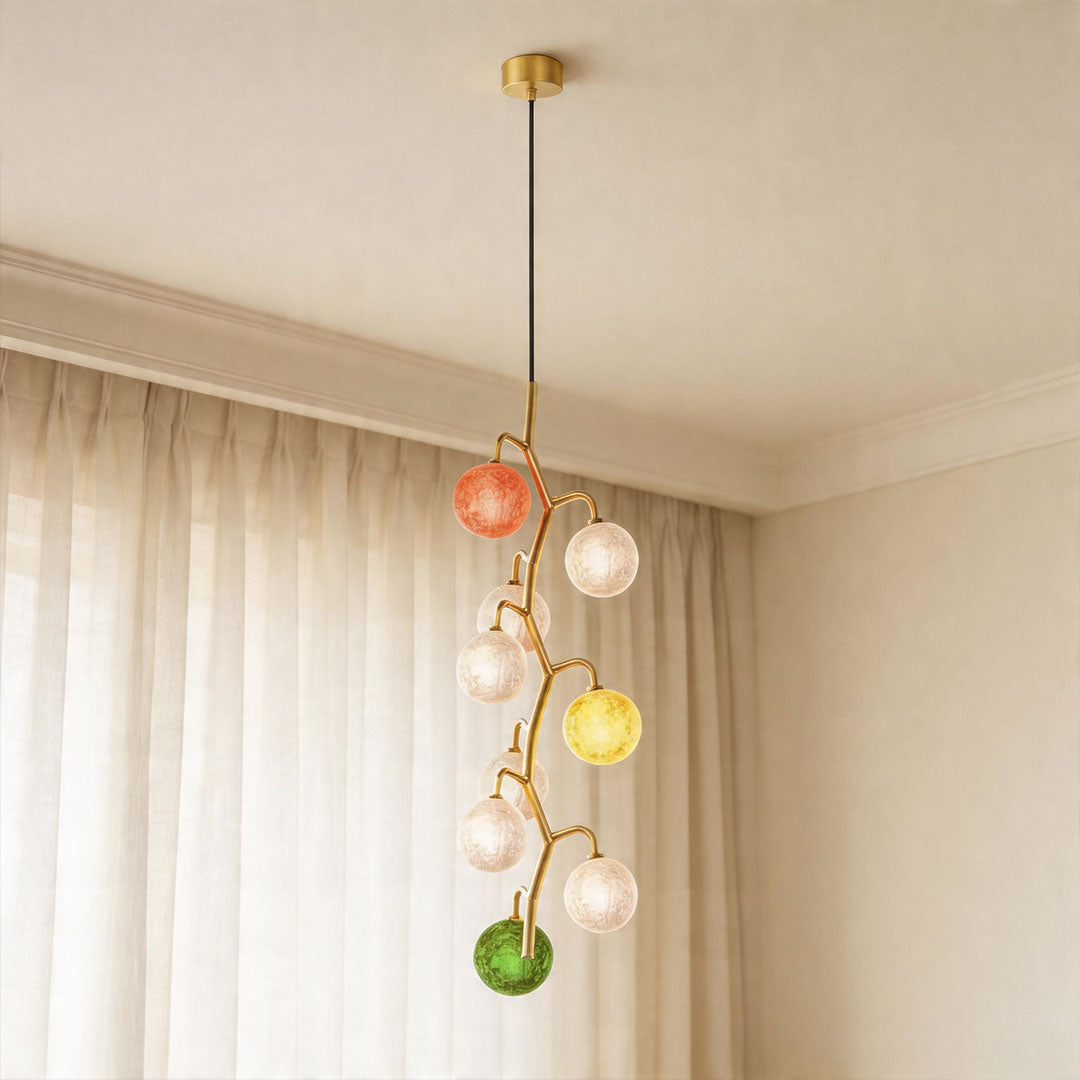 Coloured glass chandelier with cascading multi-color globes in modern living room.