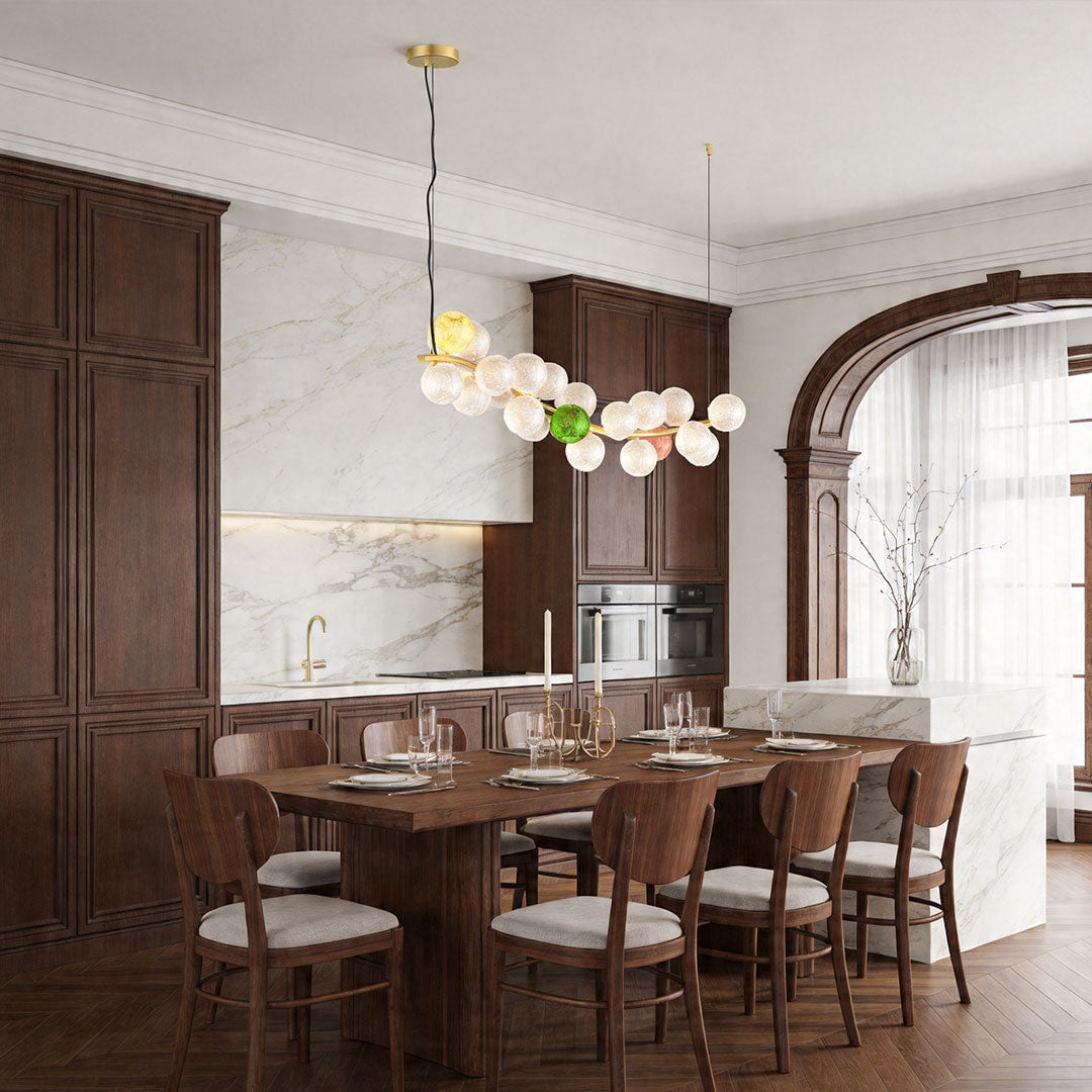 Large coloured glass chandelier above dining table with vibrant globe lighting.