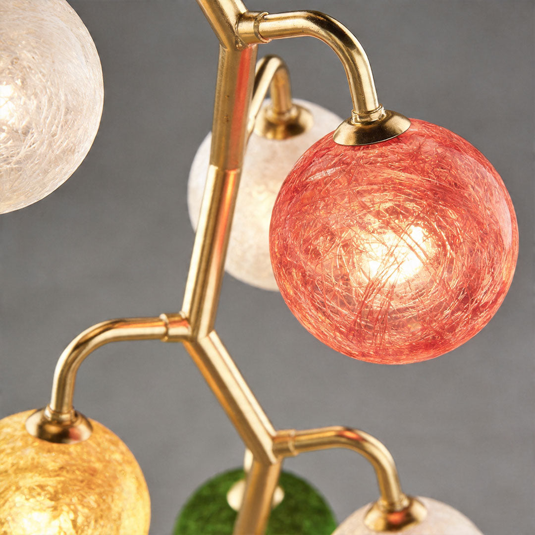 Close-up of coloured glass globe showing textured surface and warm illumination.