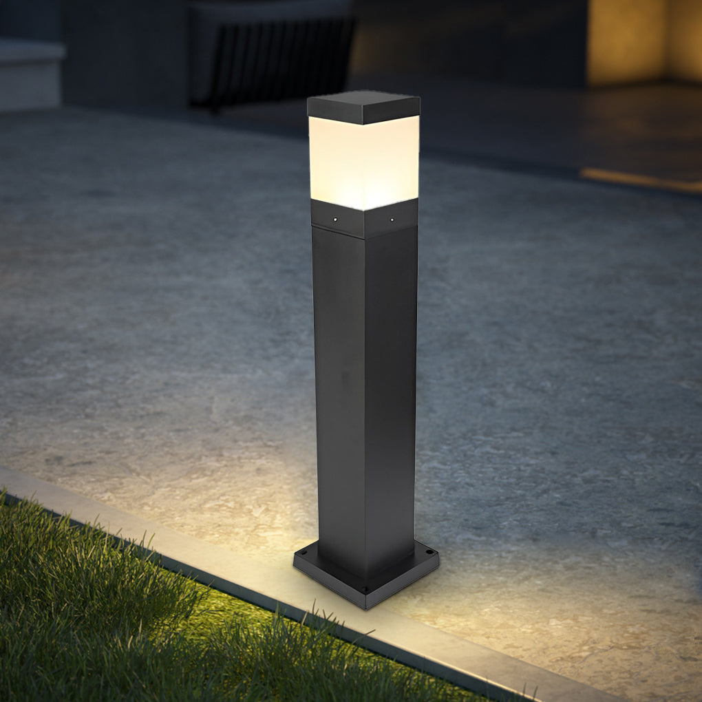 Commercial bollard lights with minimalist black finish illuminating a garden pathway with stone steps.