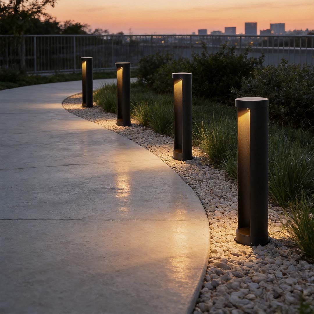 Commercial LED bollard lights illuminating a modern garden pathway with warm glow.