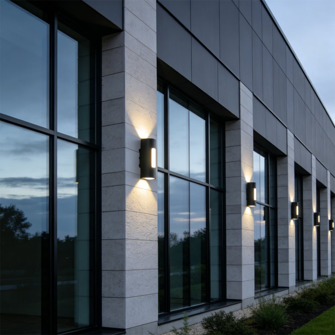 Contemporary commercial exterior illuminated by up down wall light with architectural beam effects.