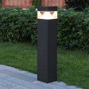 Modern square post light providing pathway illumination along commercial walkway