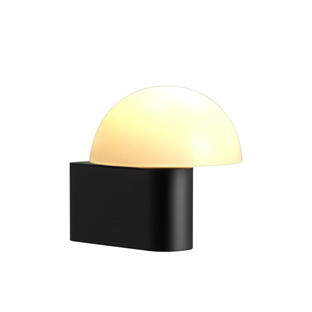Compact dome outdoor wall light sconce featuring a warm diffused glow and sleek black rectangular body.