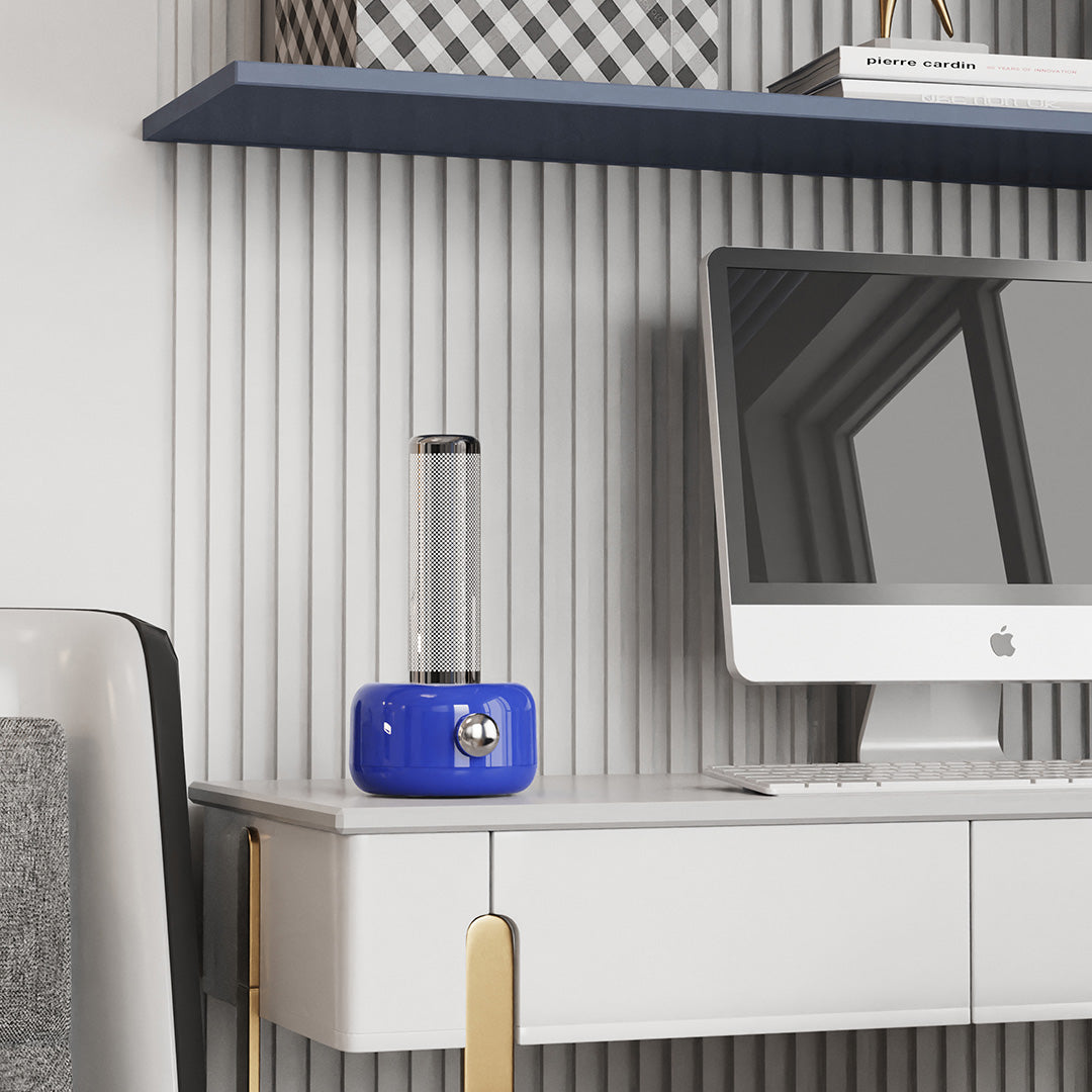 Compact industrial metal USB rechargeable table lamp displayed on modern shelving unit