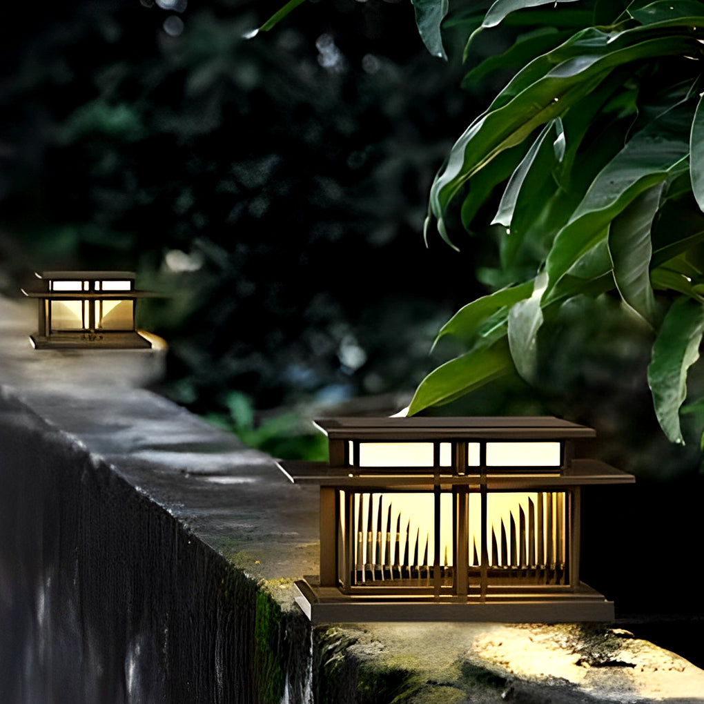 Compact porch pillar lights placed on a stone wall surrounded by garden greenery.