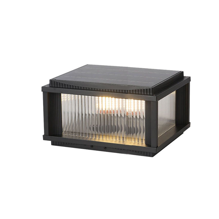 Compact solar-powered outdoor pillar light with black frame and ribbed glass panels for deck and garden lighting