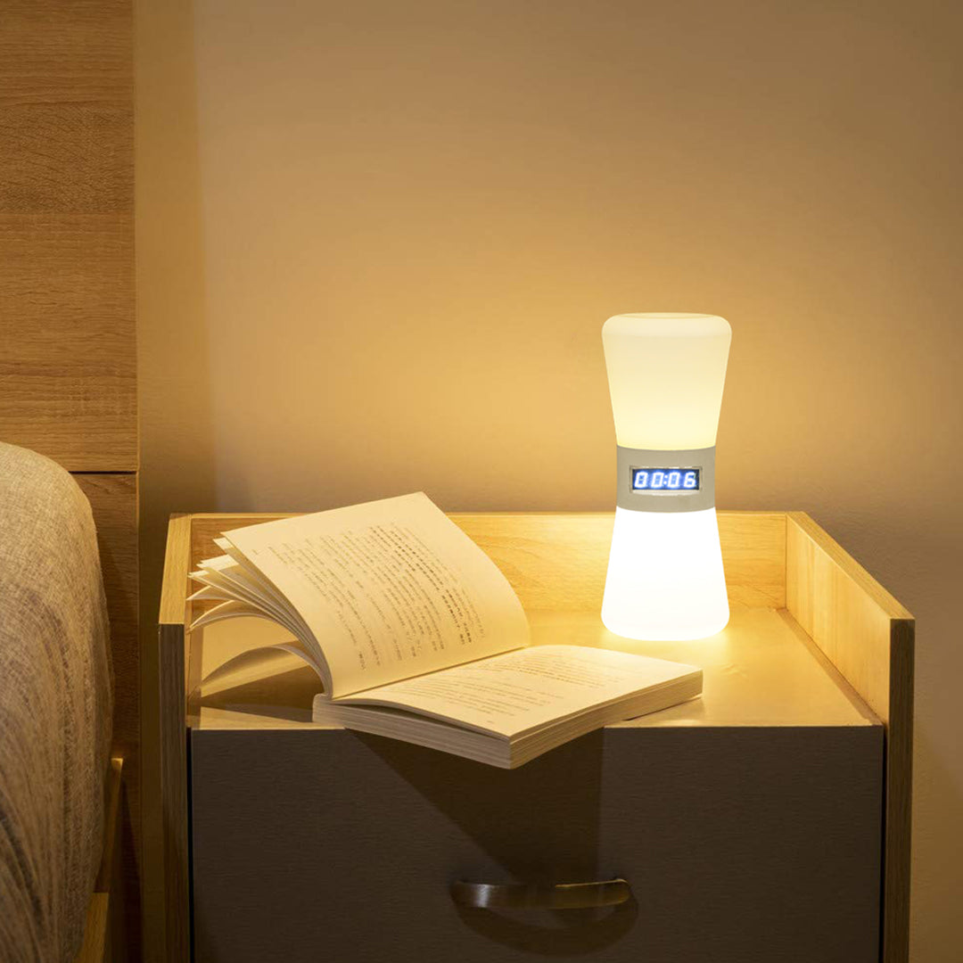 Compact white USB rechargeable table lamp creating warm reading atmosphere with open book