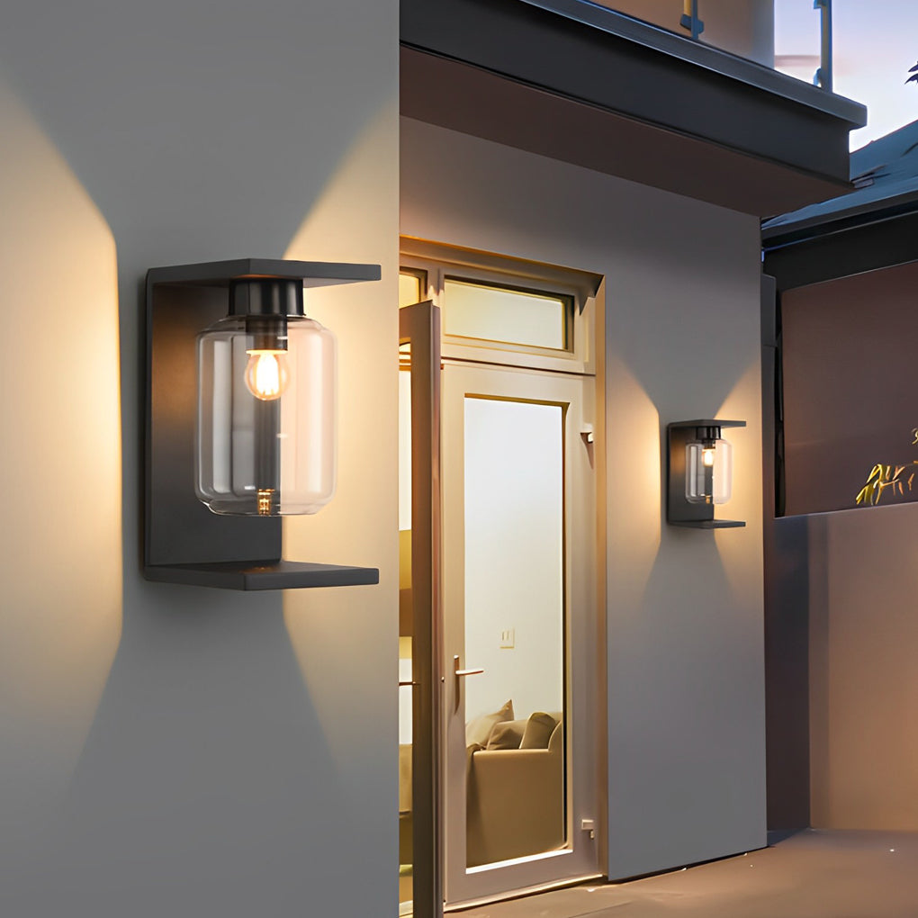 Compound wall lights outdoor with a black finish, providing warm light near a window.