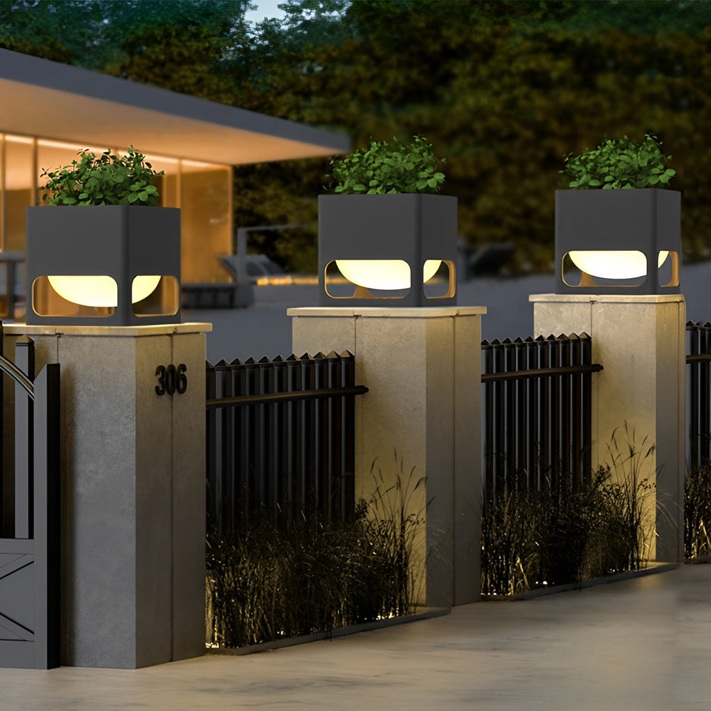 Concrete pillar lights lining a modern driveway, casting a warm glow on the pathway.