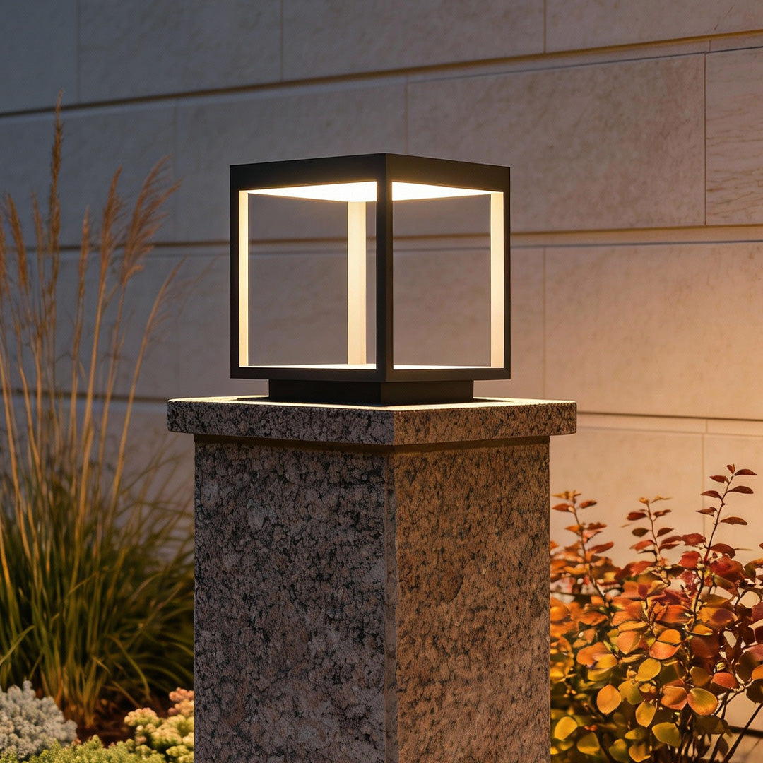 Modern concrete pillar lights installed at a residential gate entrance.