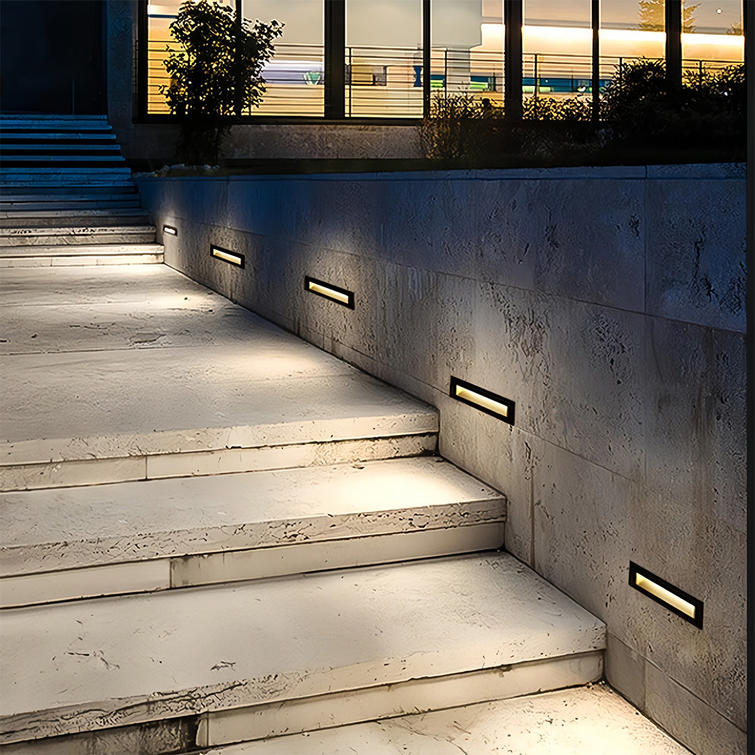 Deck lights for steps illuminating outdoor concrete stairway with modern architectural design