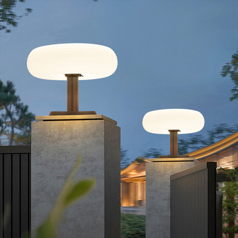 Multiple contemporary bollard lights installed along concrete walkway providing uniform pathway lighting