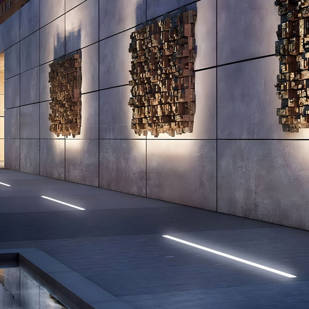 Modern concrete wall with integrated LED strip lighting creating dramatic architectural accent illumination at night