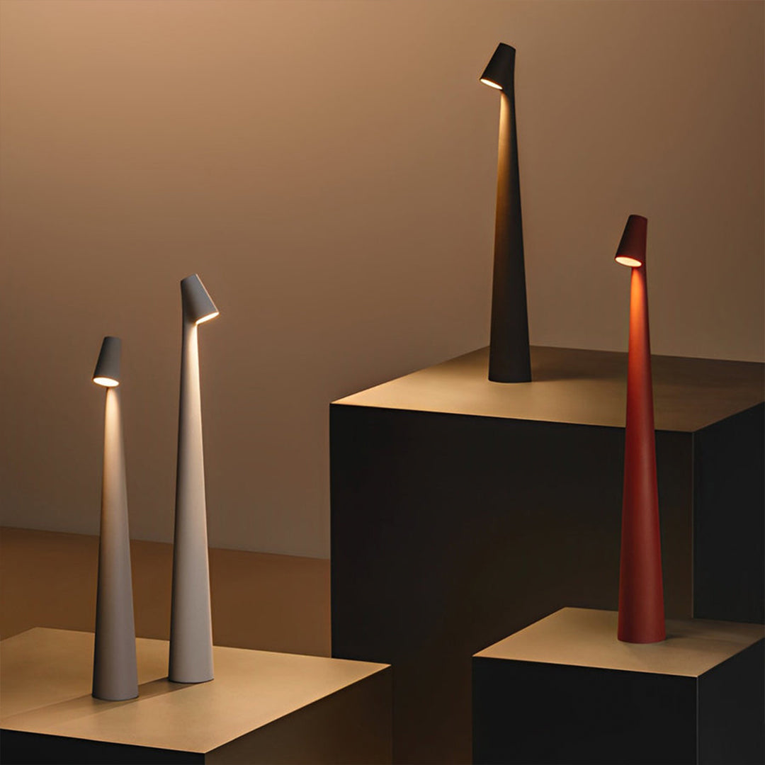 Cone shaped table lamps in black and white creating sculptural ambient lighting.