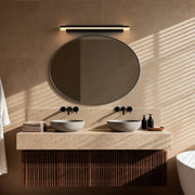 Sleek contemporary bathroom vanity lighting mounted above a mirror, providing even and bright illumination for the space.