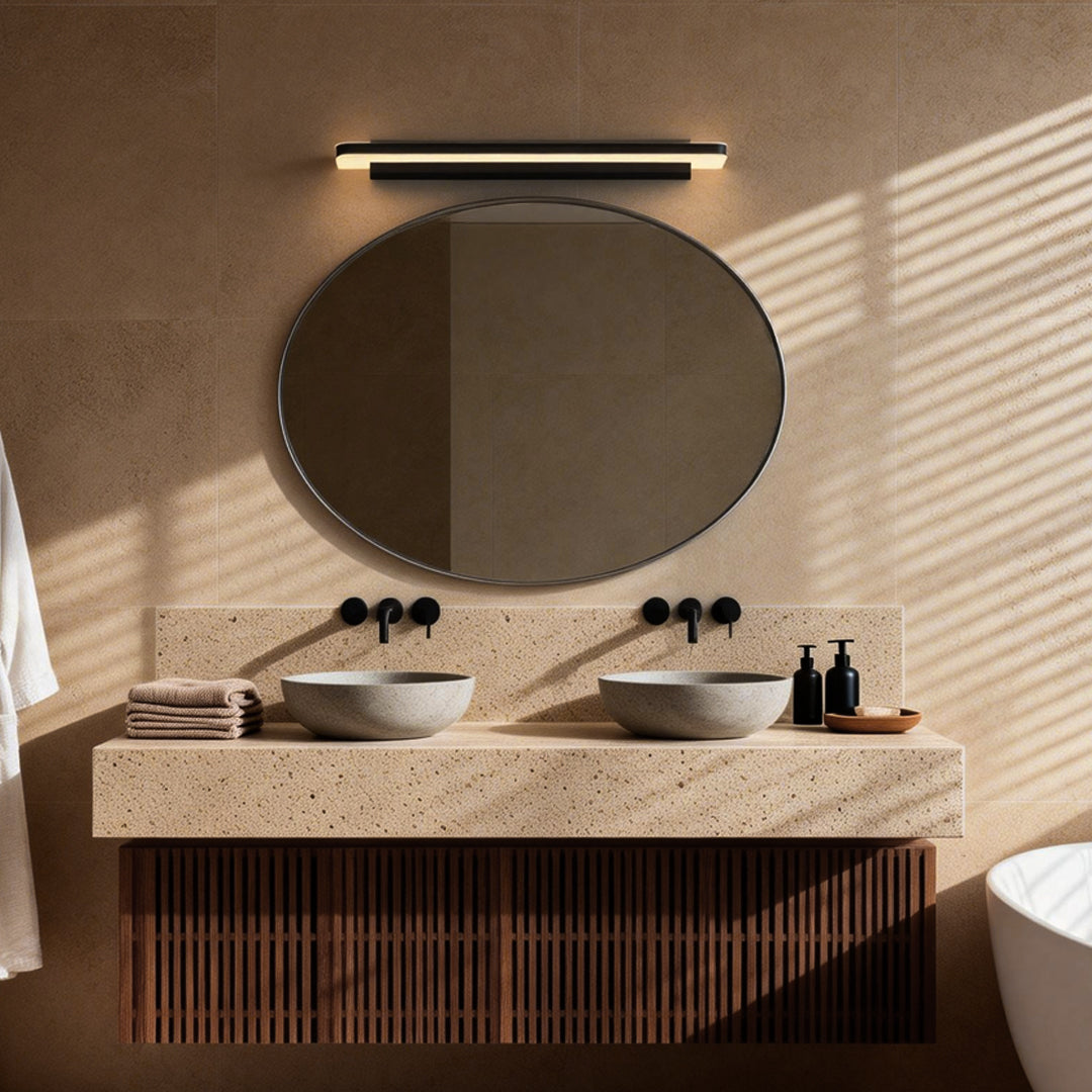 Sleek contemporary bathroom vanity lighting mounted above a mirror, providing even and bright illumination for the space.