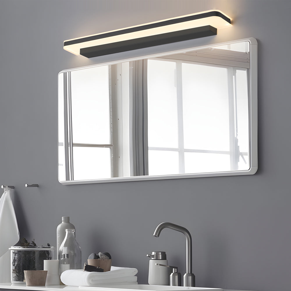 Minimalist bathroom vanity light above a large rectangular mirror, providing warm and even lighting for the vanity area.