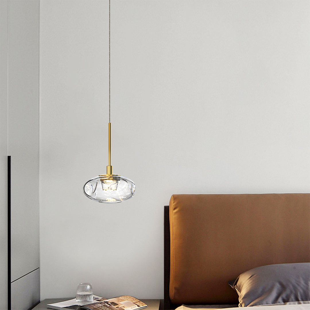 Stylish small glass pendant lights enhancing contemporary bedroom interior with warm crystal illumination