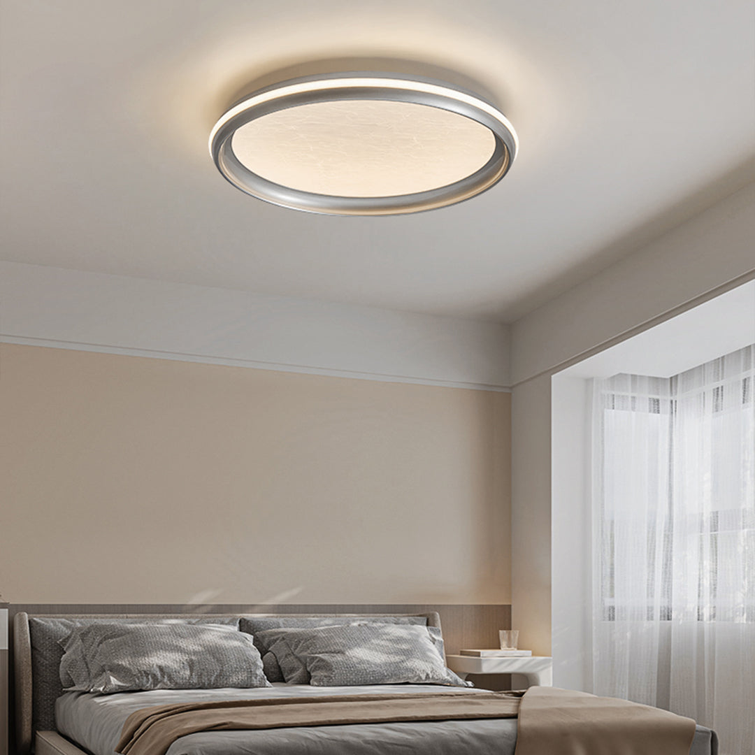 Metal flush mount light in a contemporary bedroom, sleek and modern ceiling lighting