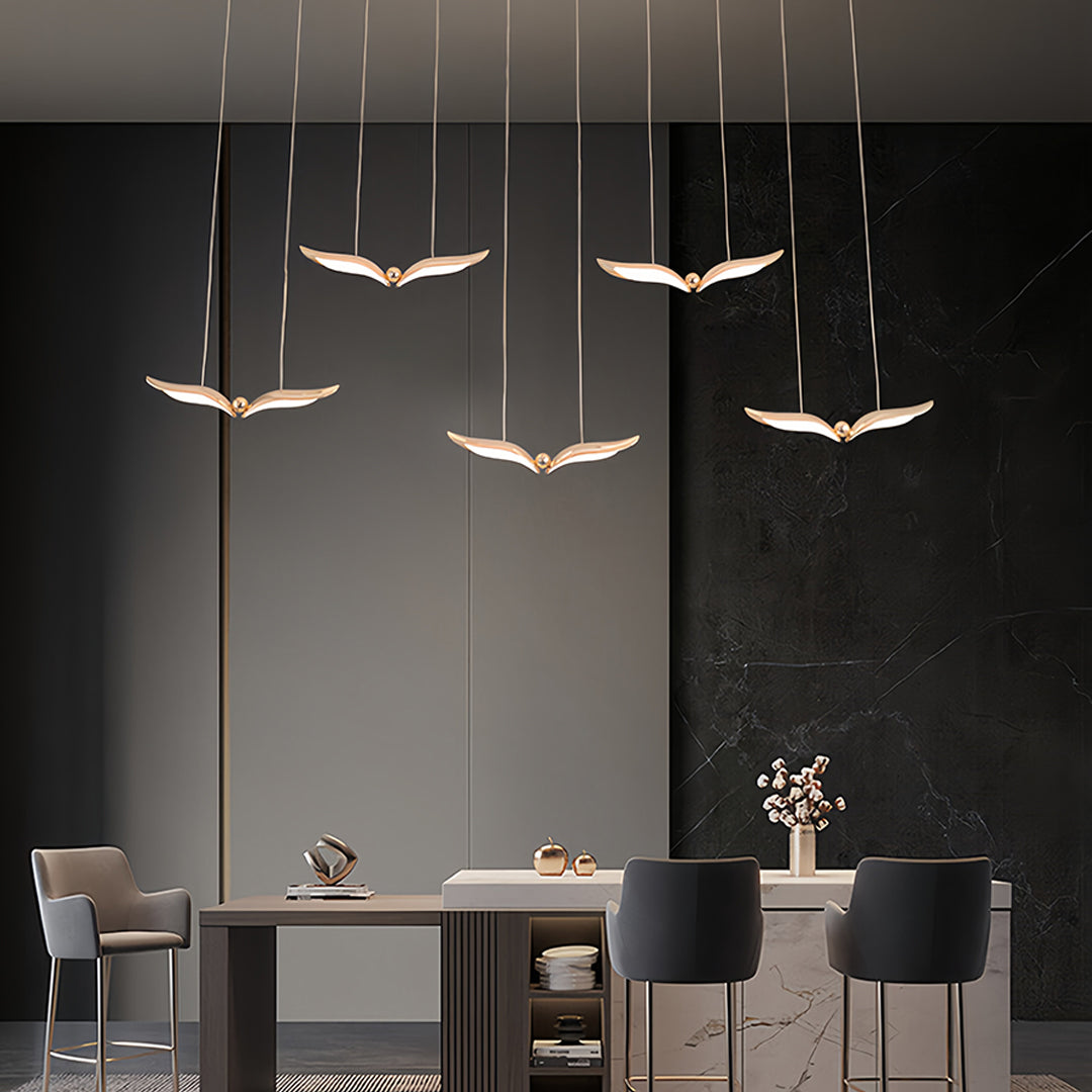 Contemporary bird pendant light creating dramatic lighting in upscale restaurant setting