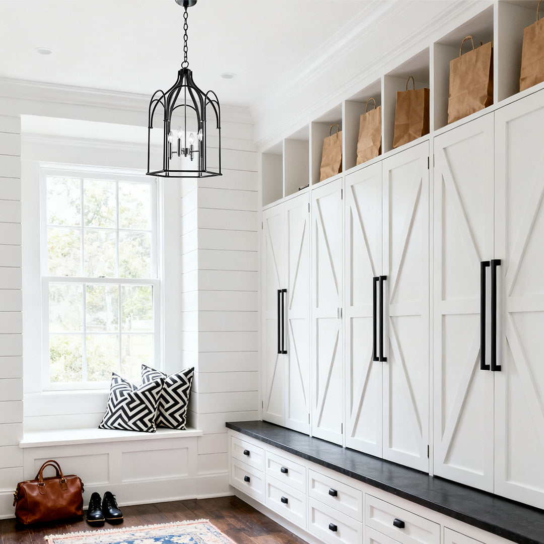 Black metal lantern chandelier with candle-style bulbs in a modern staircase area