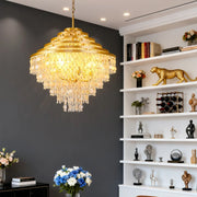 Stylish gold-tiered crystal chandelier with hanging shells in a sophisticated study room