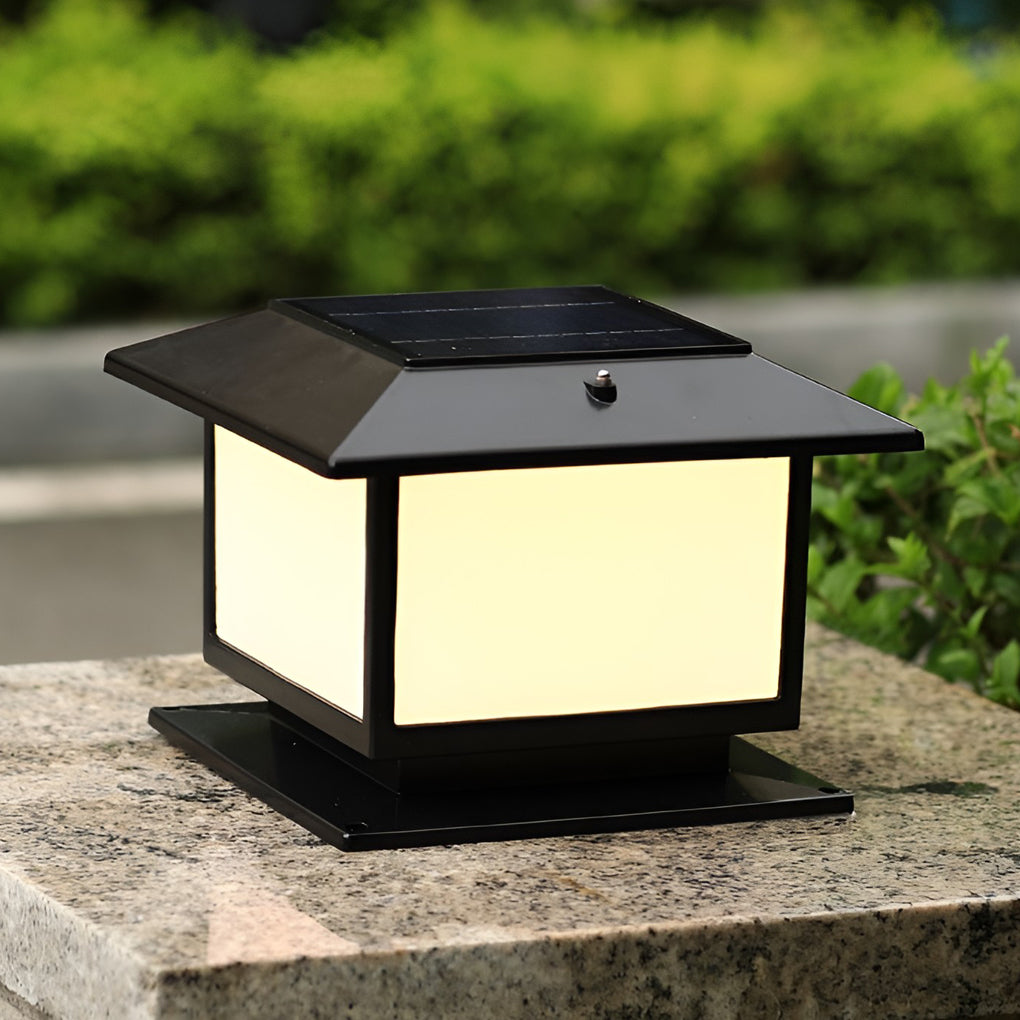 Contemporary black outdoor pillar light with a flat roof design, placed on a stone pillar for stylish outdoor lighting.