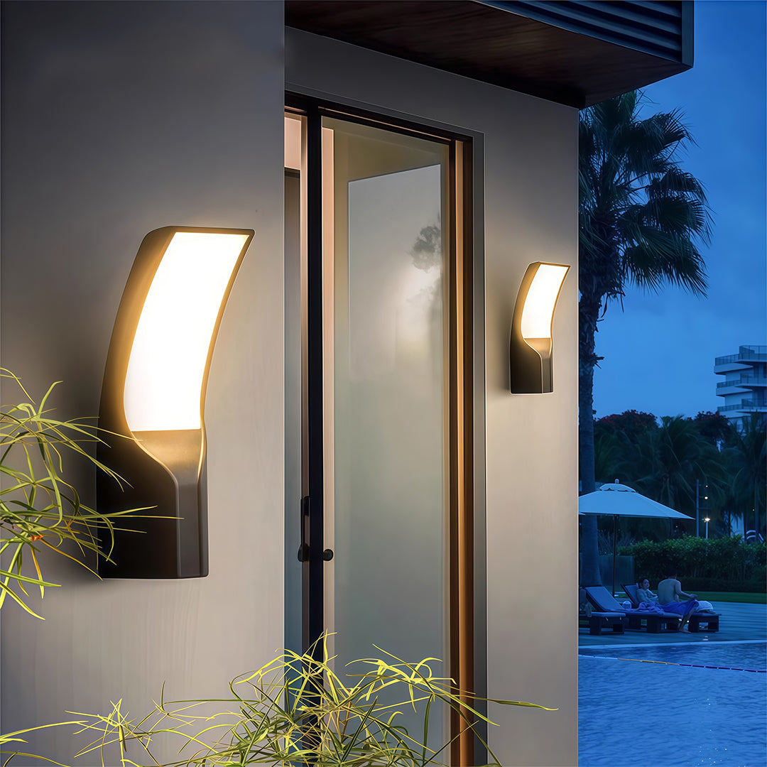 Contemporary black outdoor light mounted on a wall, enhancing the surroundings with a stylish, soft illumination.
