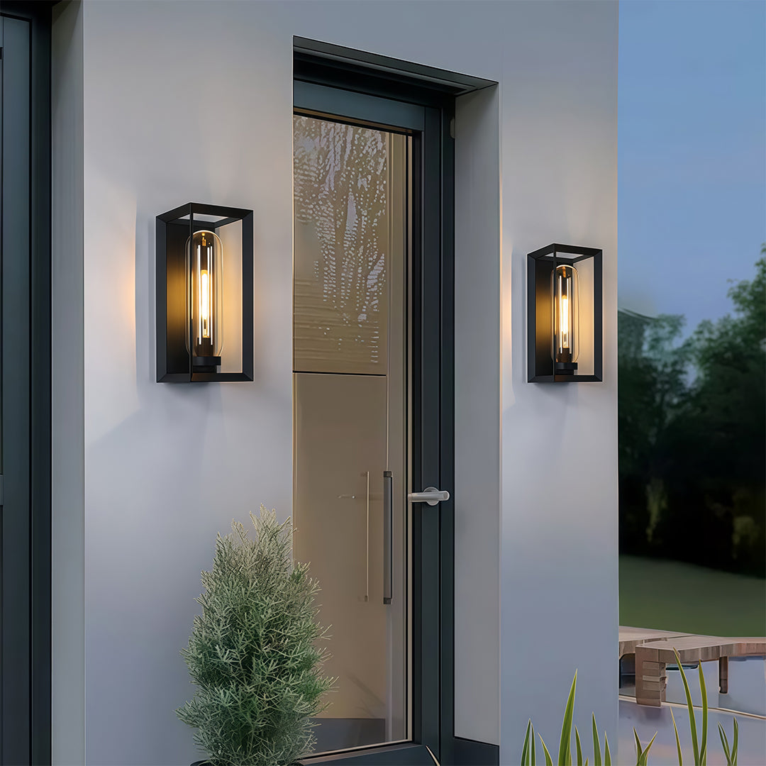 Contemporary black outdoor wall sconce modern installation on white exterior wall at twilight