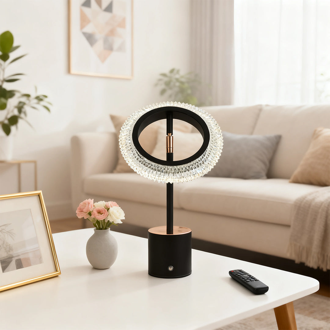 Contemporary black ring table lamp on a white coffee table, perfectly styled in a neutral-toned living room.