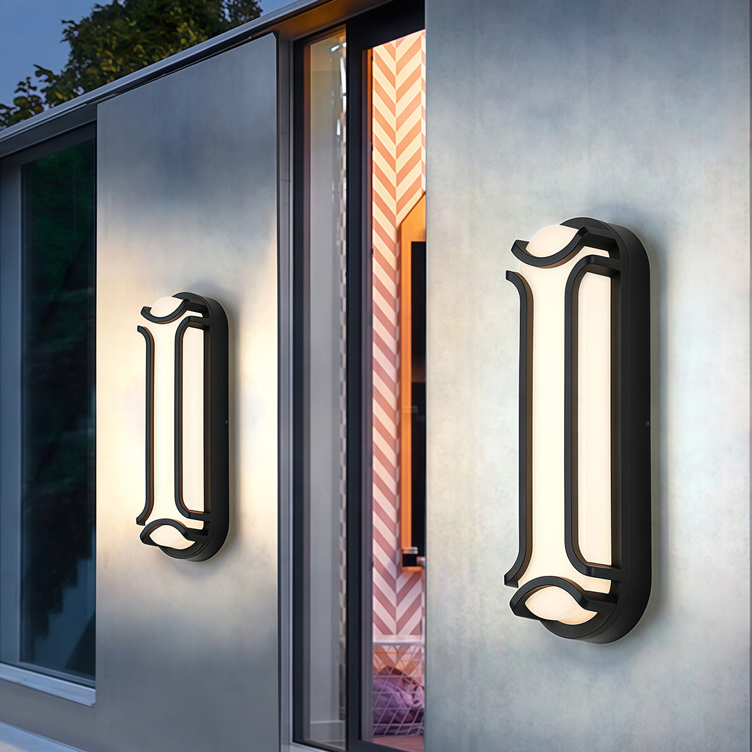 Contemporary black outdoor wall sconce, installed on a smooth exterior wall, offering ambient lighting for the surrounding area.