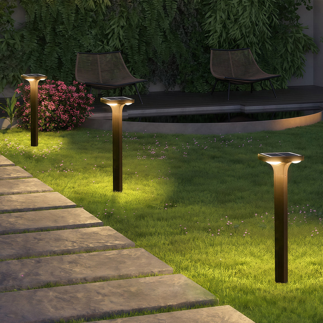 Contemporary outdoor wall light in black, mounted on a modern stone wall with a soft glow.