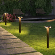 Contemporary outdoor wall light in black, mounted on a modern stone wall with a soft glow.