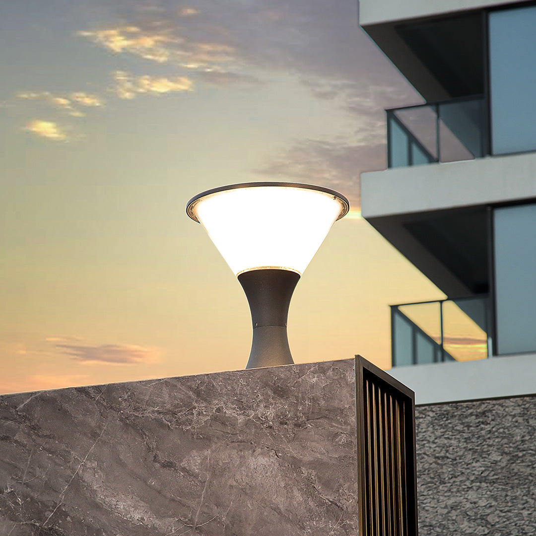 Contemporary bollard light illuminating modern building exterior during golden hour sunset lighting