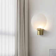 Modern wall lights combining brass elements with clear glass for contemporary interior lighting solutions