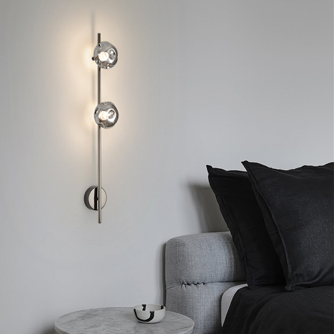 Contemporary indoor wall mounted lights with brass rod creating warm bedroom accent lighting
