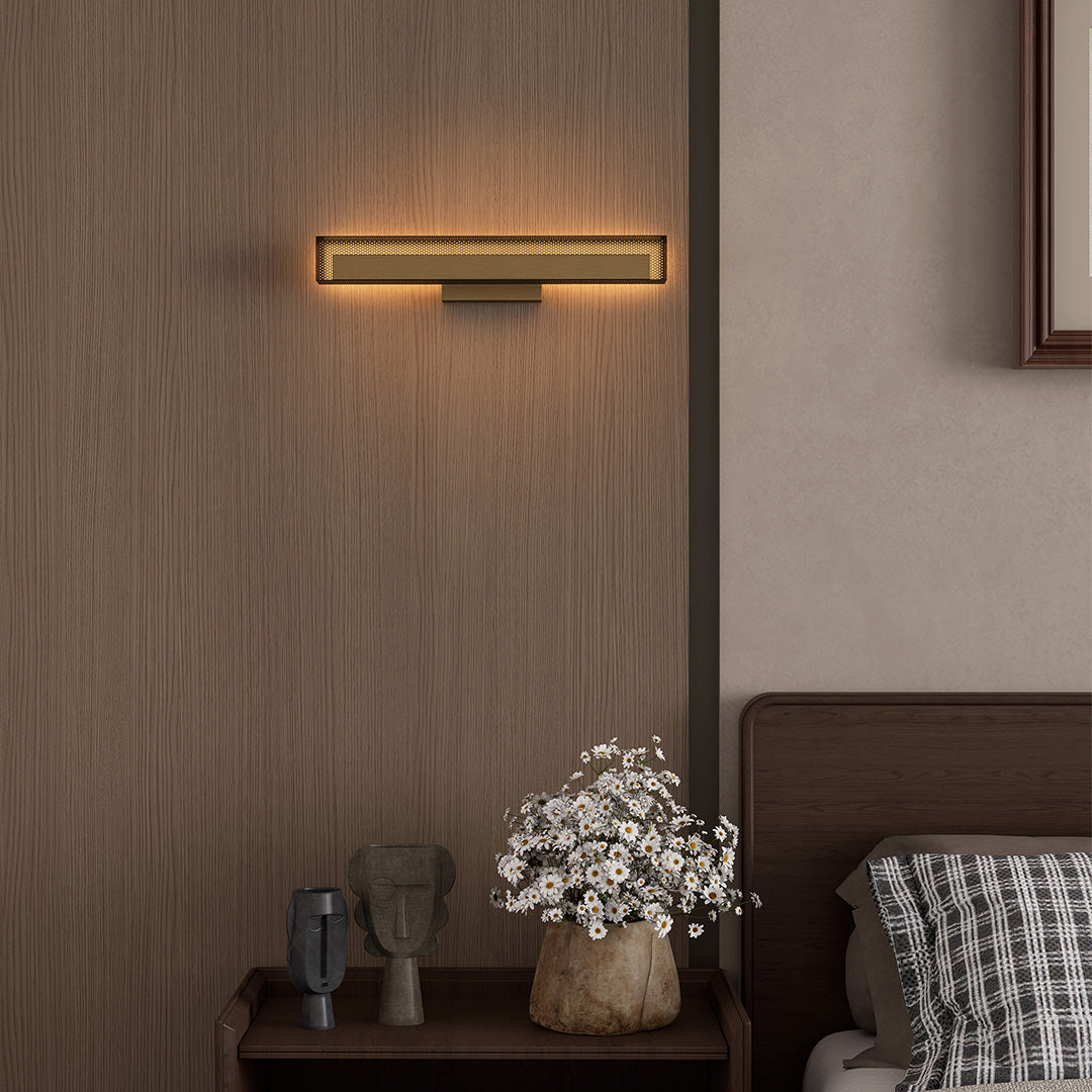 Contemporary wall picture lights in brushed brass, installed on wooden wall.