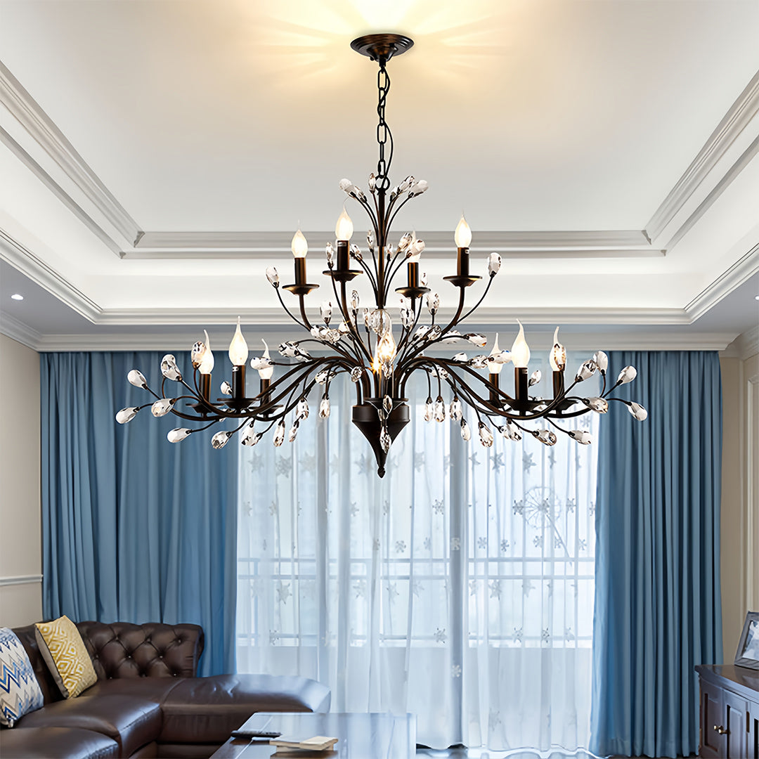 Contemporary candle chandelier with artistic black metalwork and cascading crystal elements for statement lighting