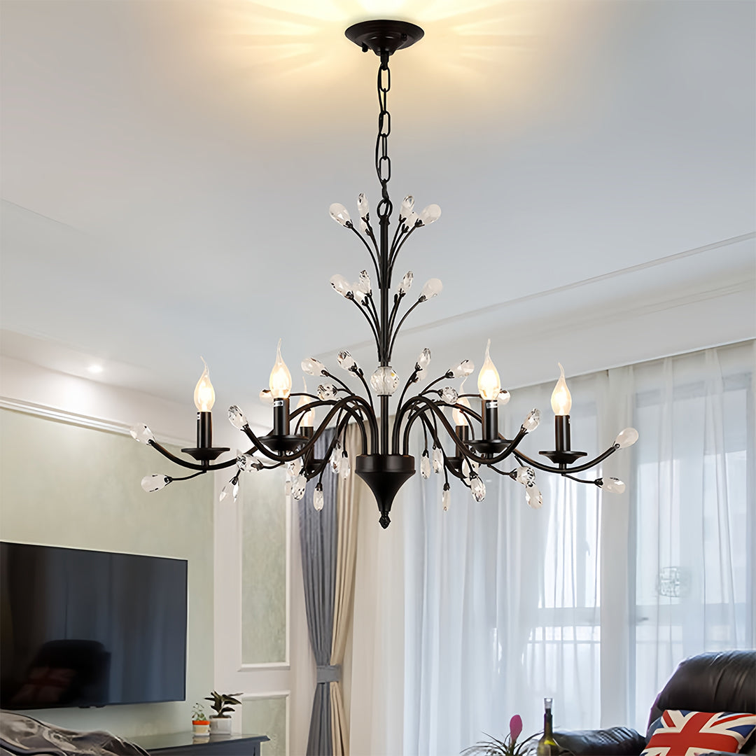 Contemporary candle chandelier detail showing black metal branch construction and crystal accent attachment points